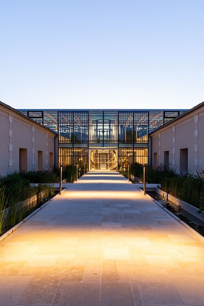 Luxurious stone facade of Chais Monnet hotel in Cognac, France, featuring elegant historic architecture with warm limestone and refined spa entrance