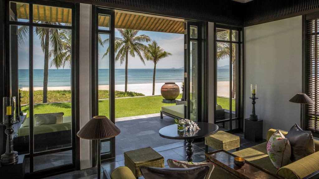 Elegant beachfront villa with private infinity pool, floor-to-ceiling windows, and modern Vietnamese design overlooking white sand beach