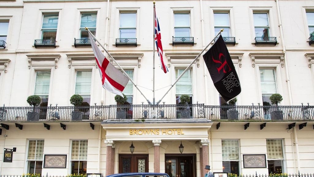 Luxurious facade of Brown's Hotel in London with ornate Victorian architecture, white-painted exterior and black iron balconies