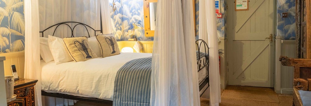 Luxurious seafront hotel room at Crab Manor with elegant maritime decor, plush bedding, and expansive ocean view through large windows