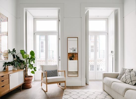 Modern, spacious one-bedroom apartment with elegant minimalist design, large windows, neutral color palette, and sleek contemporary furnishings in Lisbon.