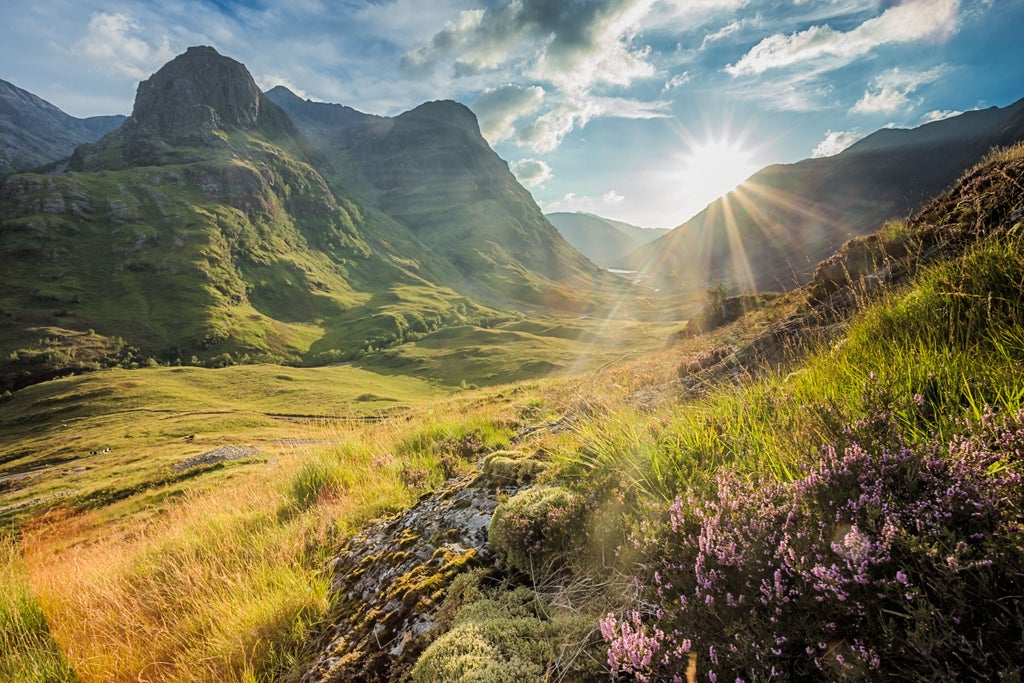 Scenic Scottish landscape with rugged Glencoe mountains, lush green valleys, and a modern gondola ascending against dramatic misty mountain backdrop