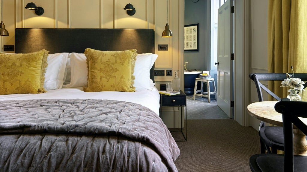 Modern luxurious hotel room with plush bedding, elegant neutral decor, large windows, and sophisticated minimalist design in neutral grey and cream tones