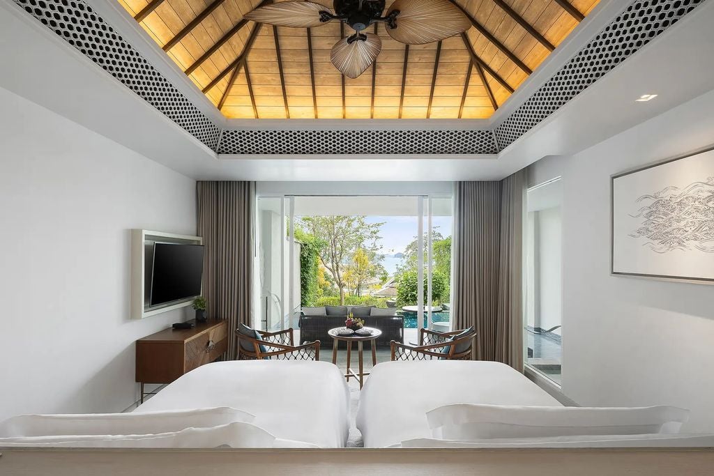 Modern twin room with plush beds, private plunge pool, tropical garden views, floor-to-ceiling windows, and contemporary Thai decor