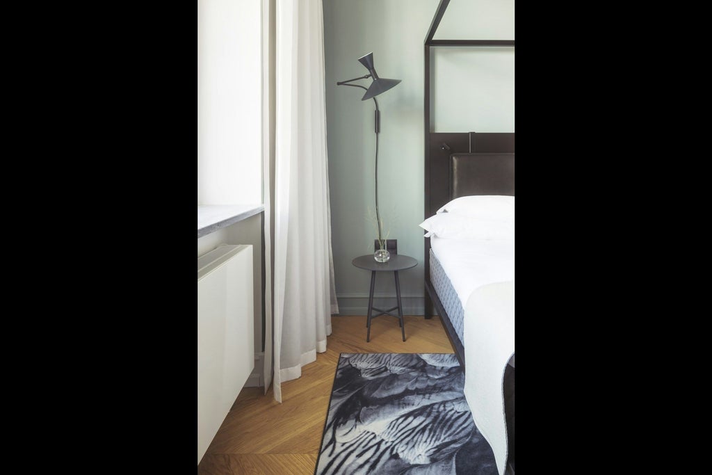 Elegant light-filled superior hotel room with modern Danish design, soft neutral tones, plush bedding, and minimalist contemporary furnishings at luxury Copenhagen hotel