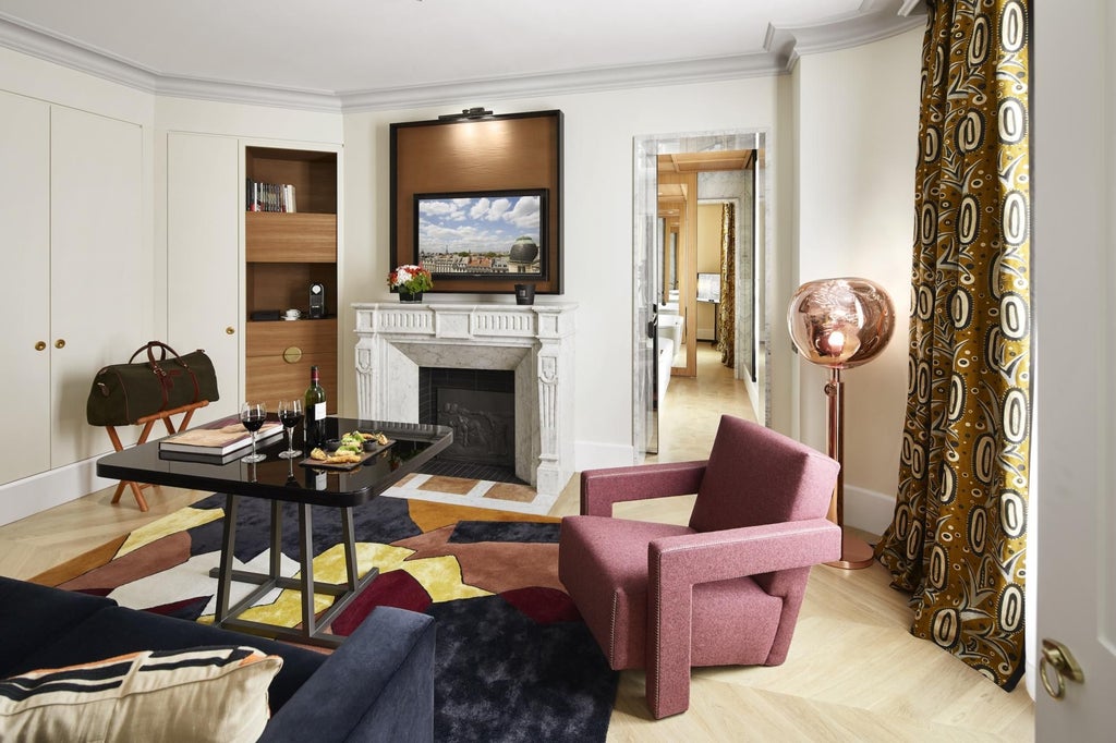 Elegant Parisian suite with contemporary design, soft neutral tones, plush king bed, luxurious marble bathroom, and expansive city-view windows in Hotel Montalembert