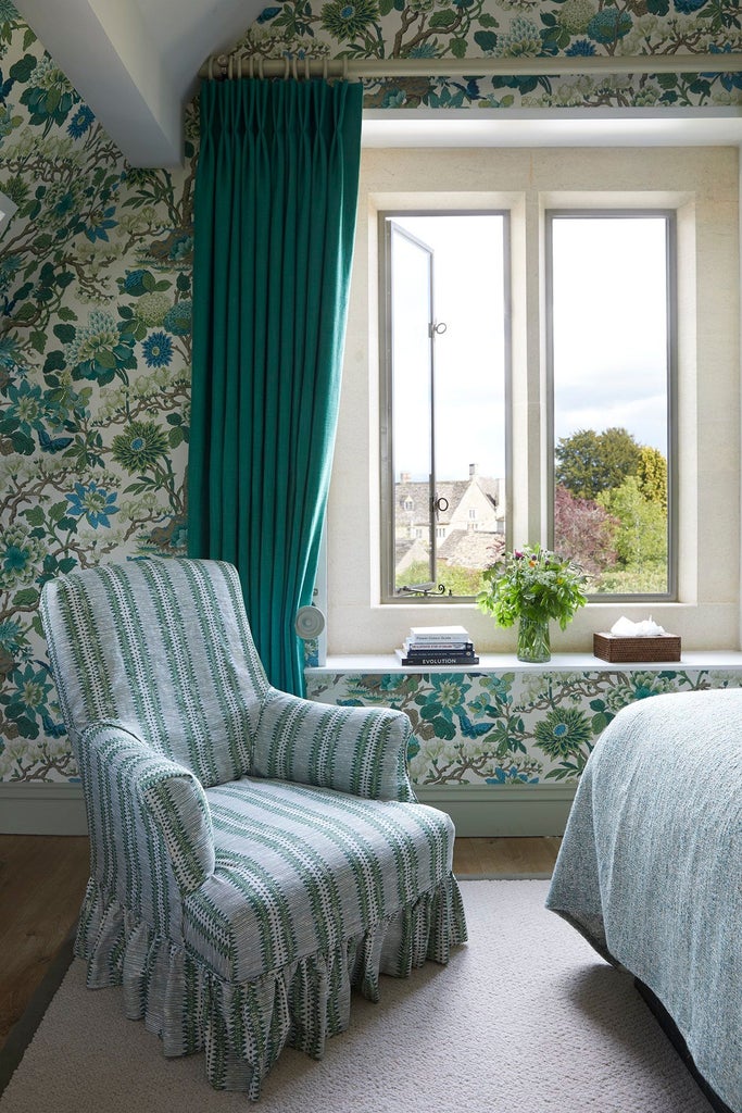 Luxurious hotel bedroom in soft neutral tones with plush bedding, elegant wooden furnishings, and sophisticated thyme-inspired design elements creating a serene retreat.