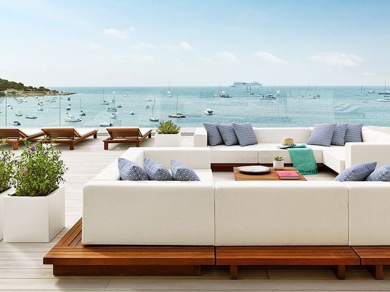 Luxurious rooftop junior suite at Nobu Hotel Ibiza Bay, featuring modern design, white furnishings, and panoramic views of the Mediterranean coastline