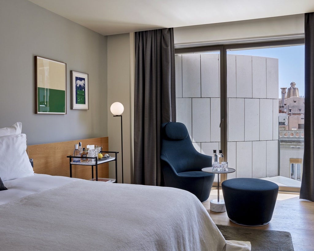 Elegant modern hotel room with minimalist design, crisp white bedding, wooden accent wall, large window overlooking urban scenery in a luxurious Spanish setting