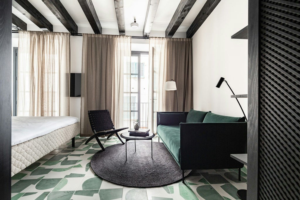 Elegant deluxe hotel room with modern Scandinavian design, plush white bedding, minimalist decor, and warm wood accents in Barcelona boutique hotel