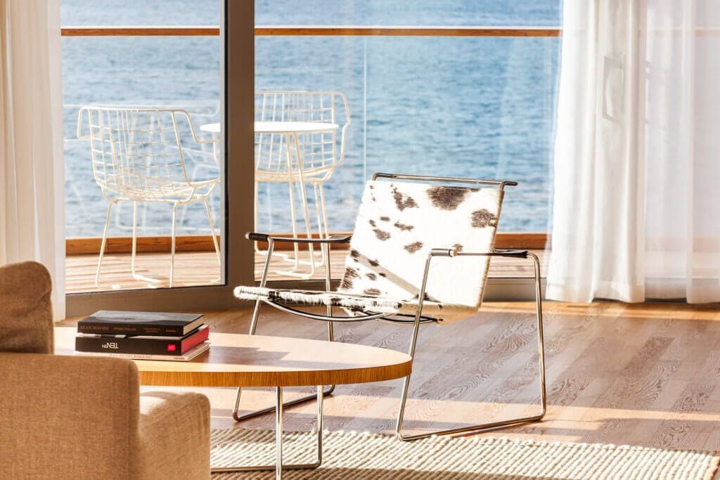 Spacious presidential suite overlooking azure Adriatic waters, featuring contemporary Croatian design with elegant white furnishings and panoramic sea view