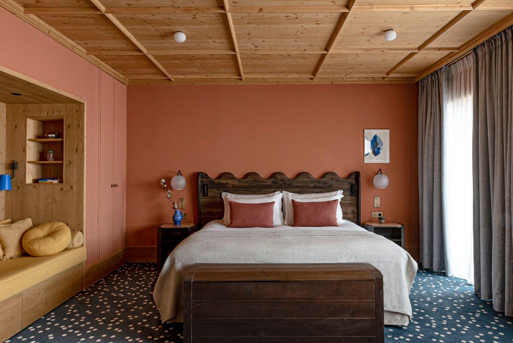 Luxurious alpine-style Prestige Junior Suite at Le Coucou Méribel, featuring soft neutral tones, elegant wood accents, and panoramic mountain view windows