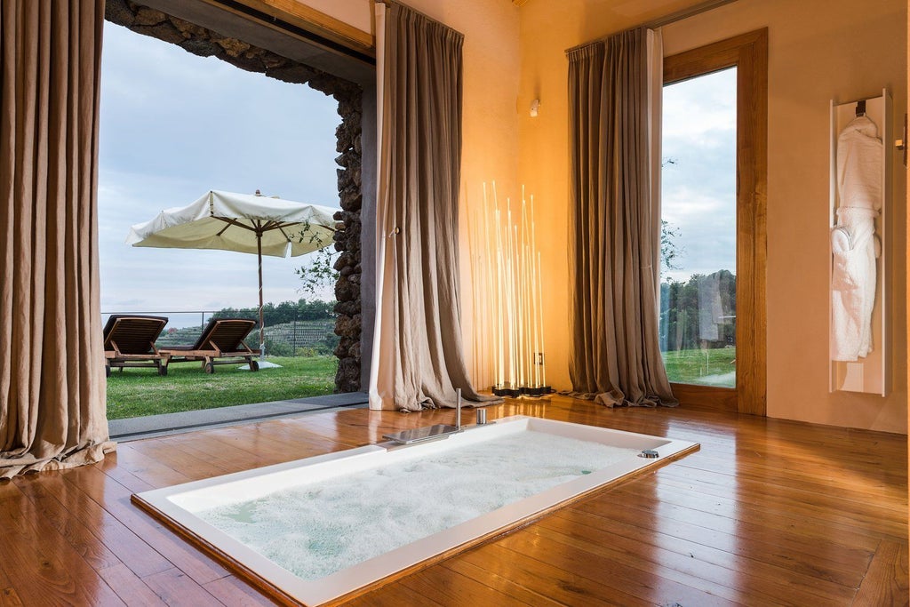 Luxurious two-bedroom pool villa at Monaci delle Terre Nere, nestled in Sicilian landscape with elegant interiors and panoramic mountain views