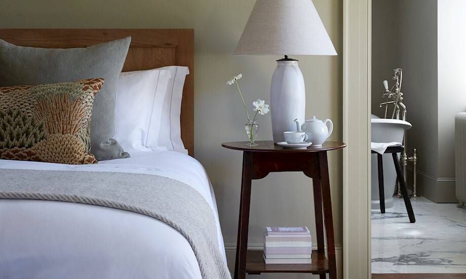 Luxurious hotel room at Heckfield Place with elegant neutral tones, natural light, minimalist furnishings, and sophisticated countryside charm in the United Kingdom