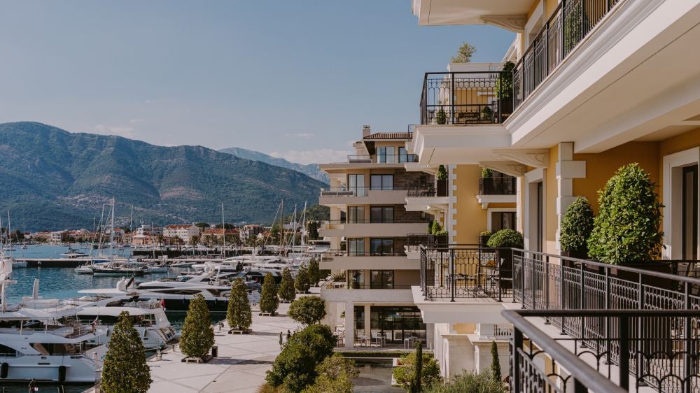 Elegant five-star hotel overlooking Porto Montenegro marina, featuring Mediterranean architecture and waterfront luxury suites