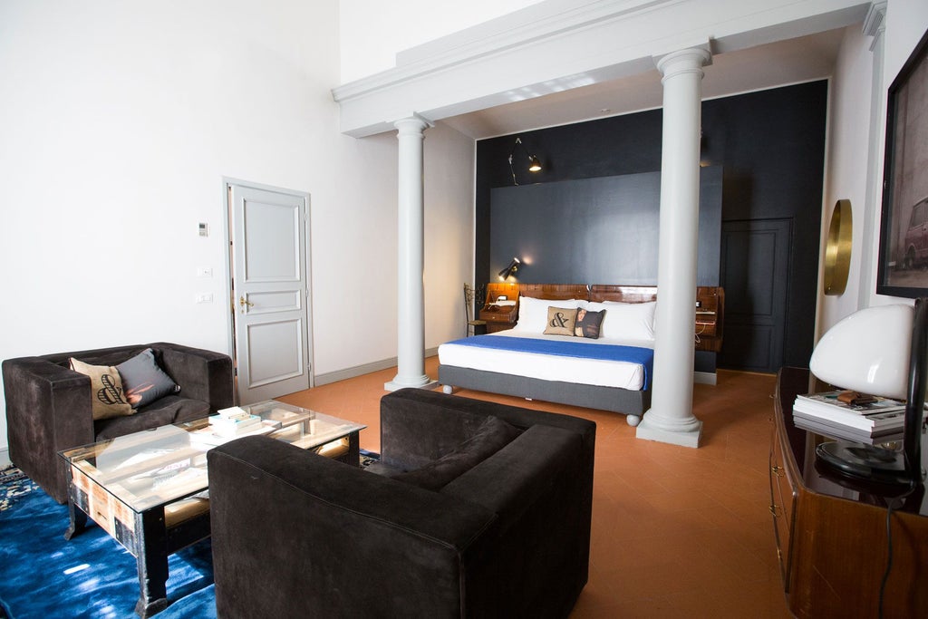 Elegant Italian boutique hotel room with ornate vintage furnishings, high ceilings, soft neutral tones, and intricate architectural details in Florence