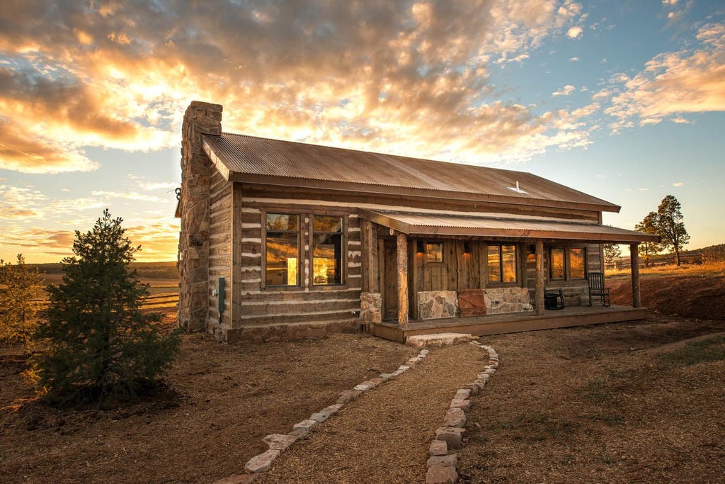 Rustic luxury cabin nestled in scenic mountain landscape, with wooden exterior, panoramic views of [Scenic Mountain Range], warm natural lighting at golden hour