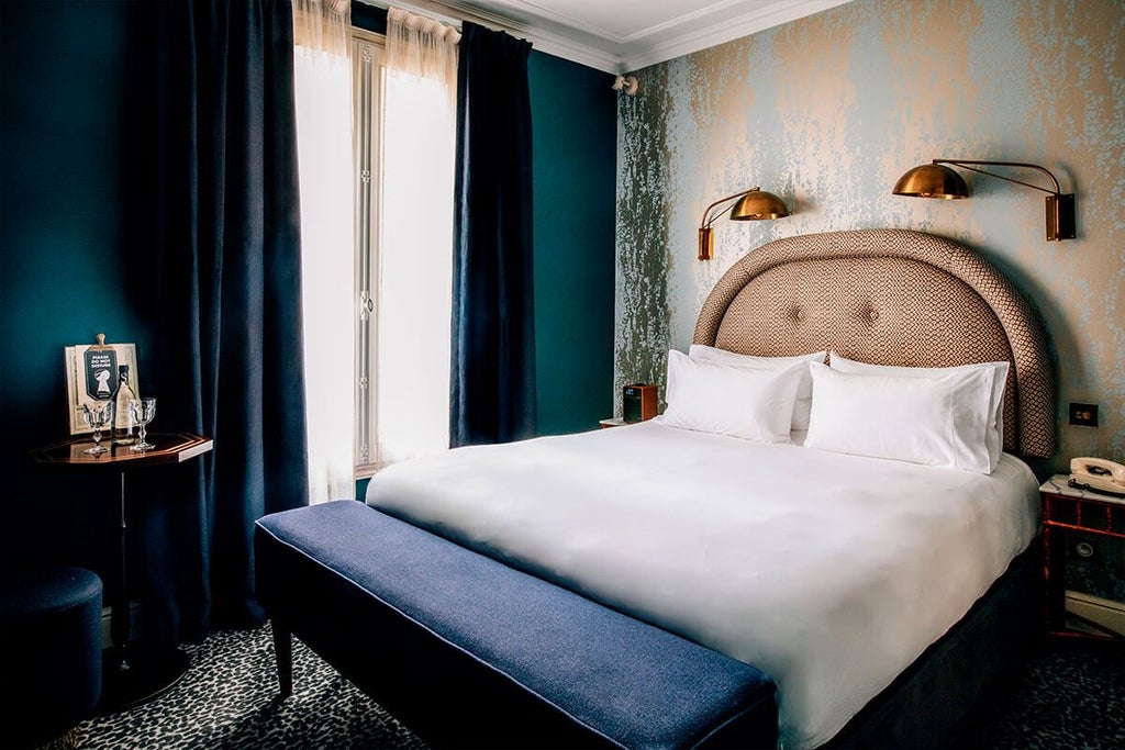 Elegant Parisian hotel room with plush bedding, ornate wallpaper, classic French design, and soft ambient lighting in warm, sophisticated tones