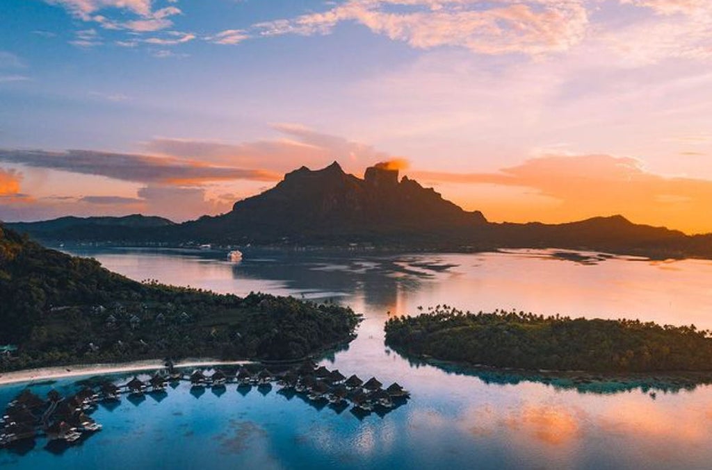 Luxurious overwater bungalows at Conrad Bora Bora with turquoise lagoon views, private decks and Mount Otemanu backdrop at sunset