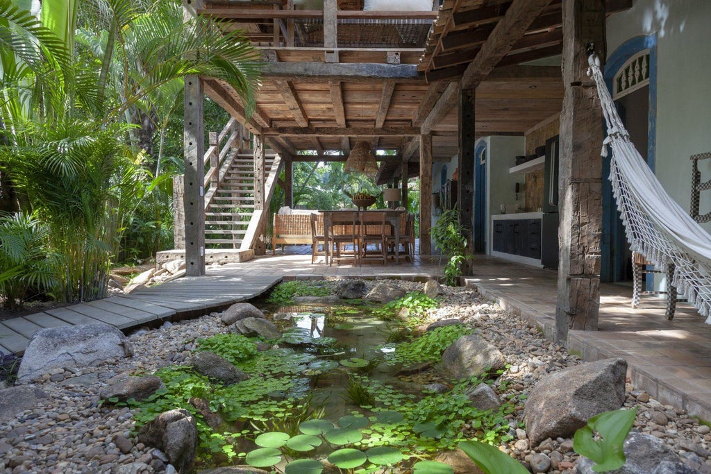 Rustic wooden interior of luxurious lakeside suite at UXUA Casa Hotel, featuring minimalist design, natural textures, and warm tropical ambiance in Brazil