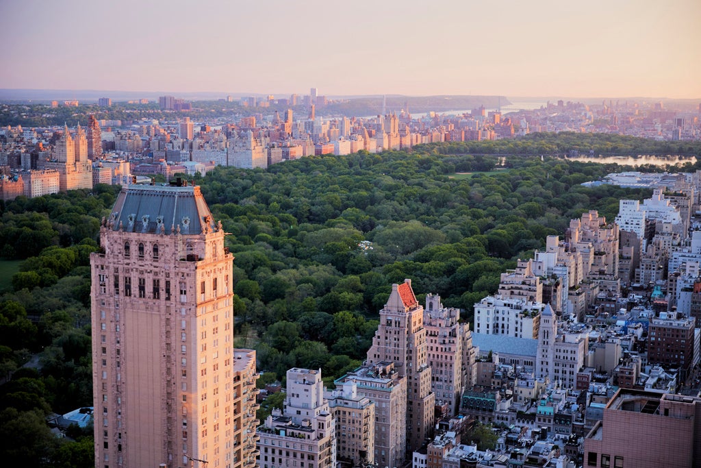 Elegant glass skyscraper of Four Seasons Hotel New York soars above Midtown Manhattan, featuring Art Deco-inspired architecture