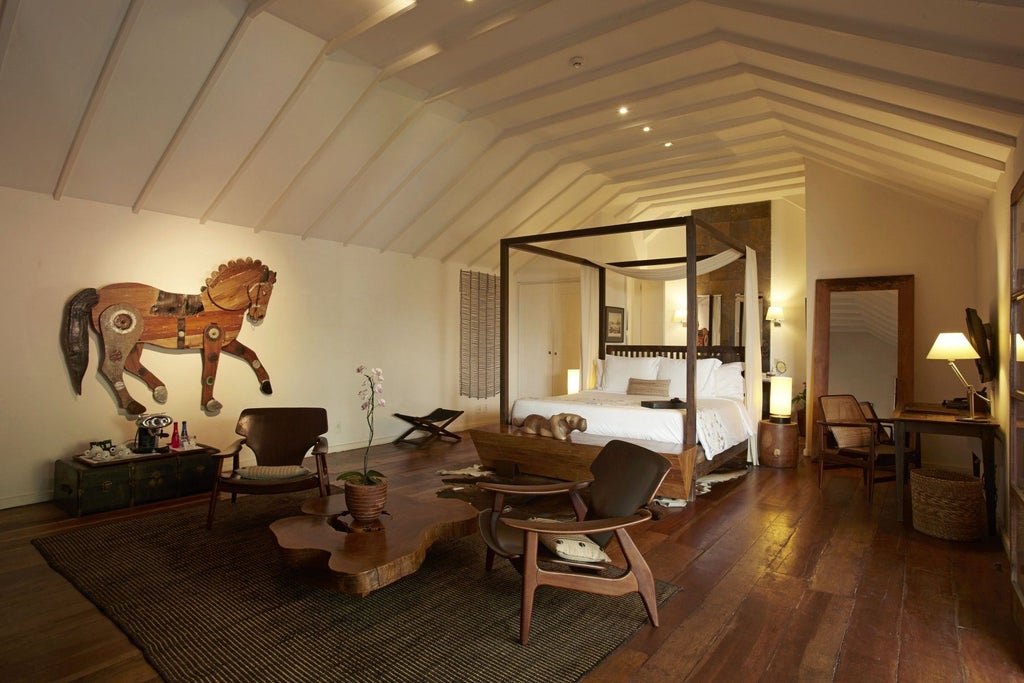 Elegant junior suite at Santa Teresa Hotel RJ, featuring luxurious wooden floors, contemporary furnishings, and large windows overlooking Brazilian landscape