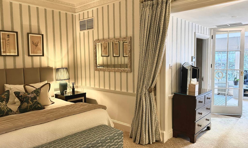 Luxurious family suite at The Royal Crescent Hotel & Spa, featuring elegant decor, plush bedding, and sweeping views of historic United Kingdom architecture