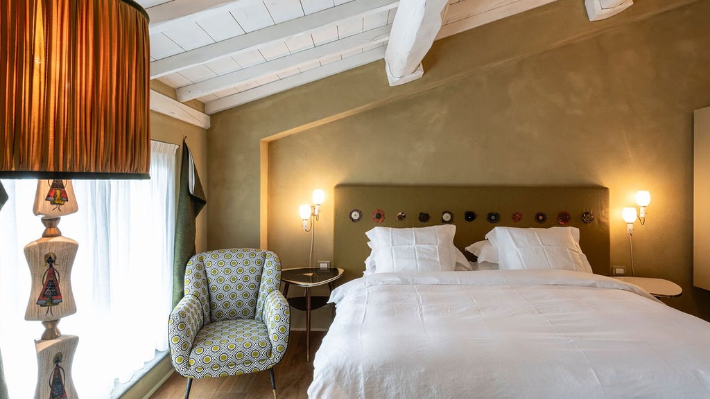 Elegant Italian hotel room with minimalist design, soft neutral tones, panoramic window revealing Tuscan countryside landscape at sunset