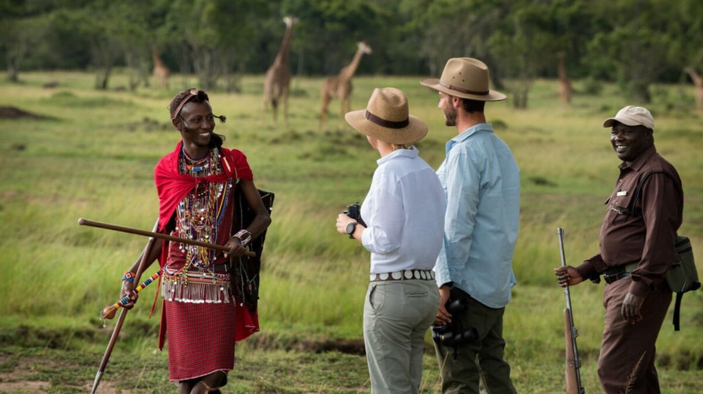 Luxury safari tent overlooking vast Masai Mara grasslands, with golden sunset casting warm light on acacia trees and distant wildlife silhouettes