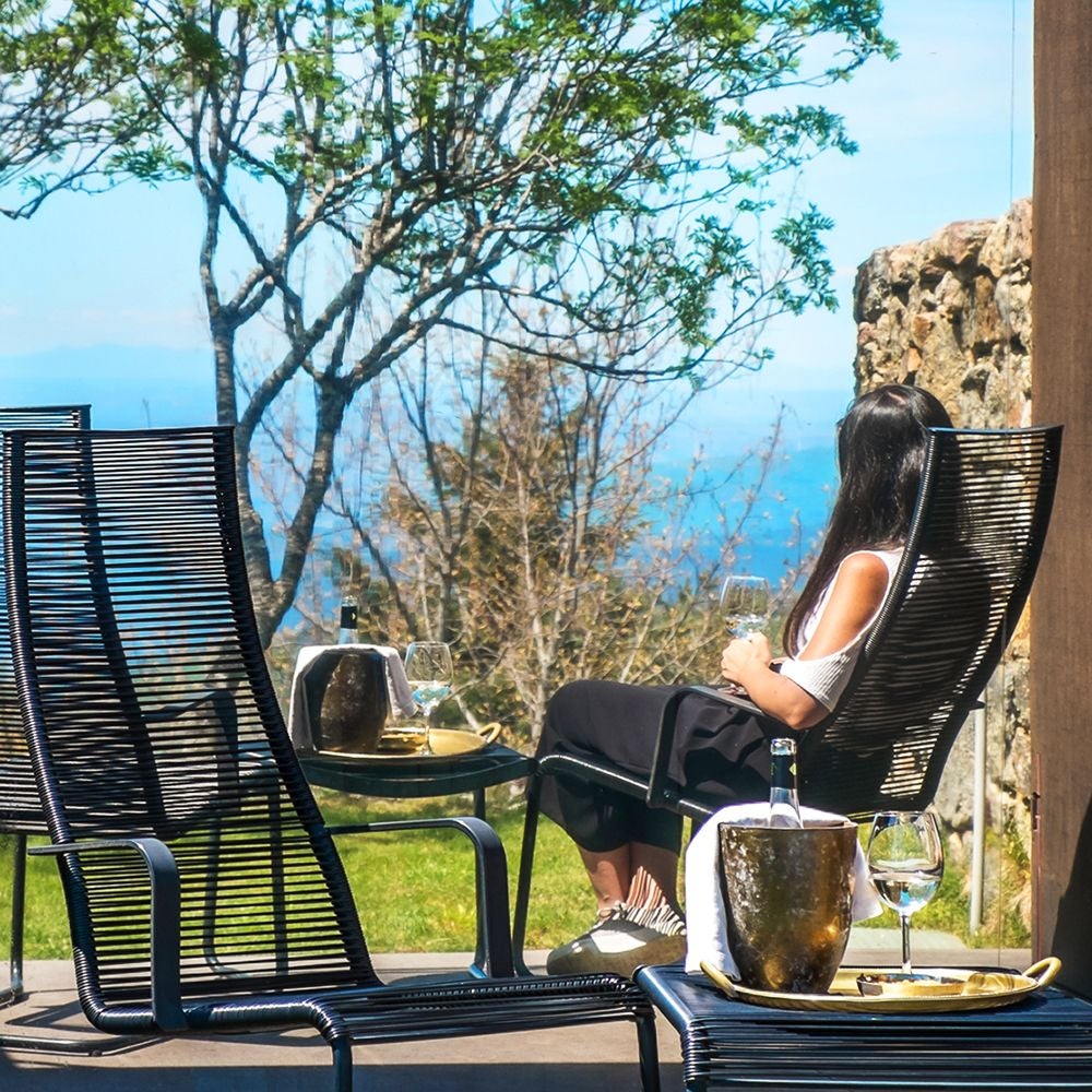 Elegant mountain-view double room with wooden furnishings, private balcony, and soft natural light at Casa das Penhas Douradas boutique hotel in Portugal.