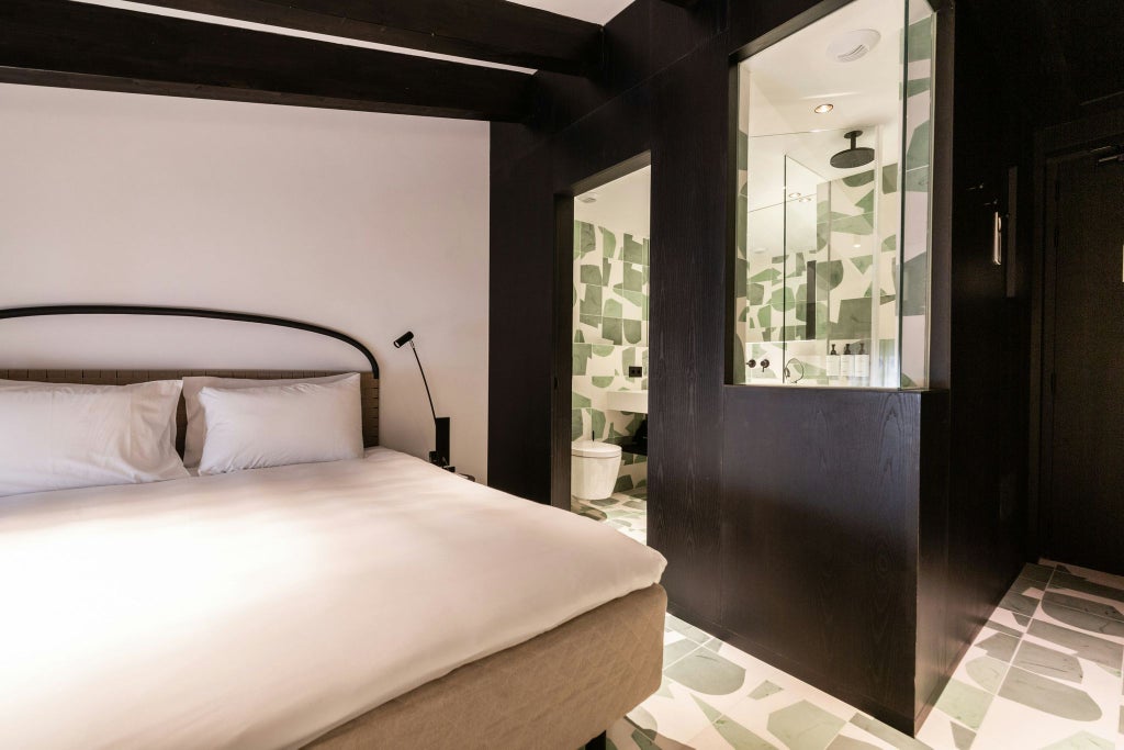 Elegant attic-style standard double room with minimalist Nordic design, white walls, wooden floors, and soft natural lighting in Spain's Hotel Concepció