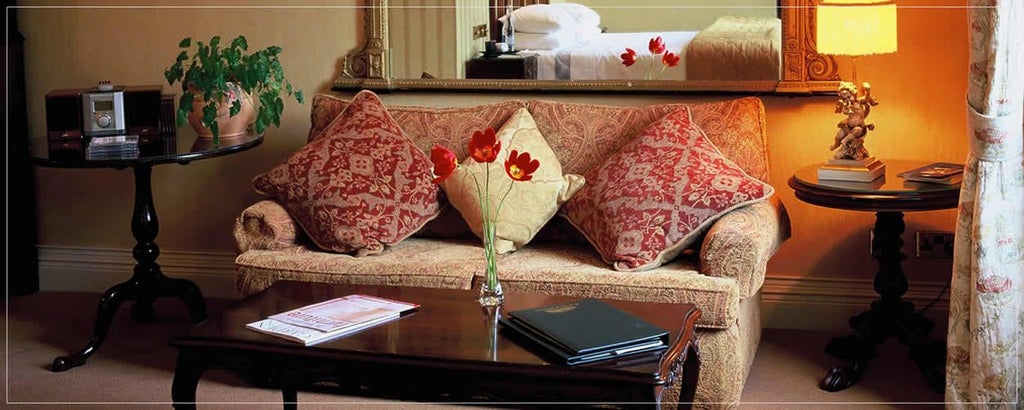 Spacious superior hotel room with elegant neutral decor, plush king bed, large windows overlooking scenic Irish landscape at Park Hotel Kenmare