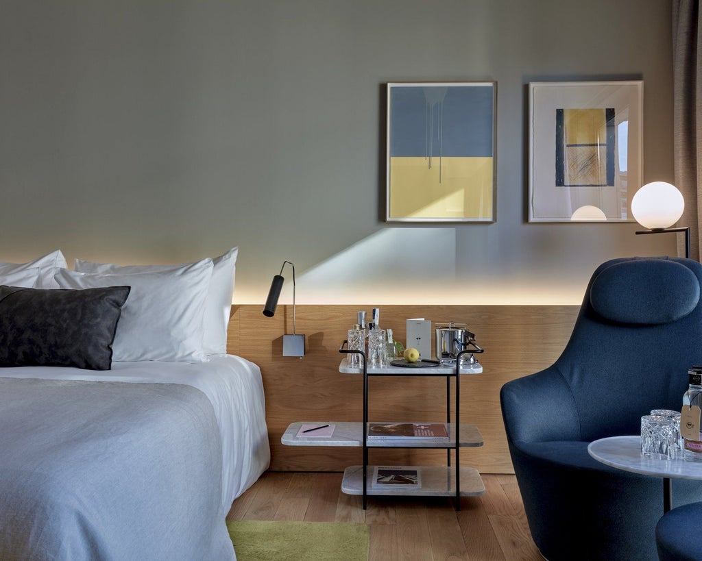 Luxurious modern hotel room at Sir Victor, featuring sleek minimalist design, crisp white linens, city view, and elegant contemporary Spanish architectural elements