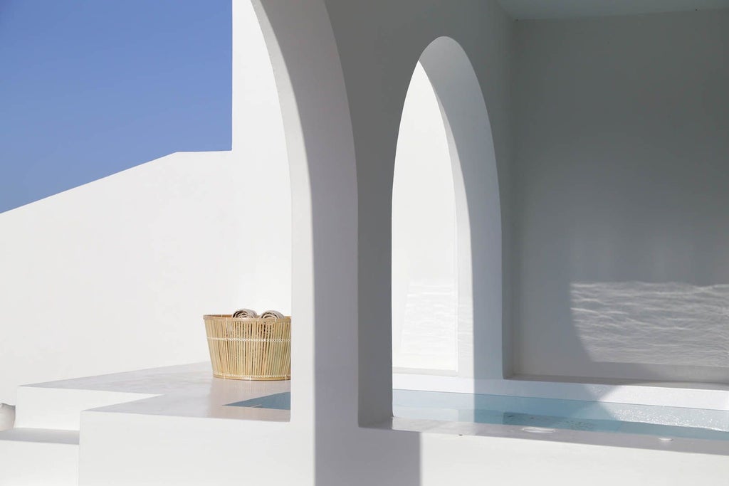 Luxurious whitewashed Greek villa with blue accents, nestled on a cliffside overlooking the azure Aegean Sea, featuring traditional Cycladic architecture