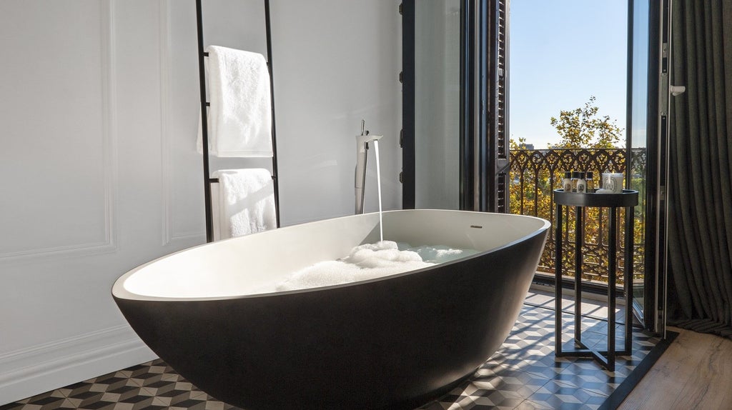 Luxurious boutique hotel overlooking Barcelona's Gothic Quarter, featuring elegant white balconies and historic architecture with modern design elements