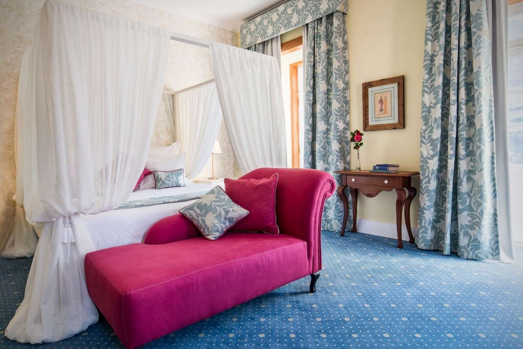 Elegant deluxe suite at Vintage House Hotel, featuring classic Portuguese decor, plush king bed, and panoramic river view with warm, inviting ambiance