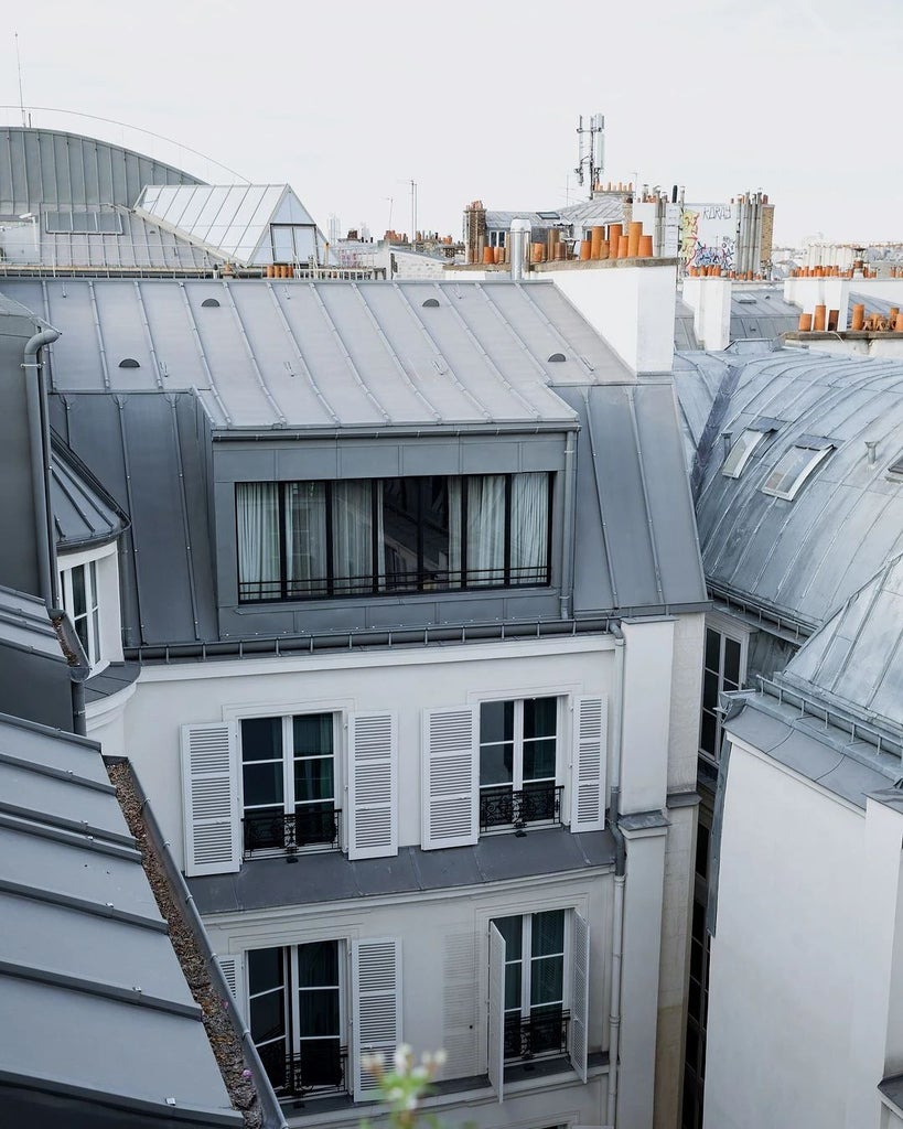 Luxurious penthouse suite at Hôtel National des Arts & Métiers in Paris, featuring elegant modern design, plush furnishings, and panoramic city views