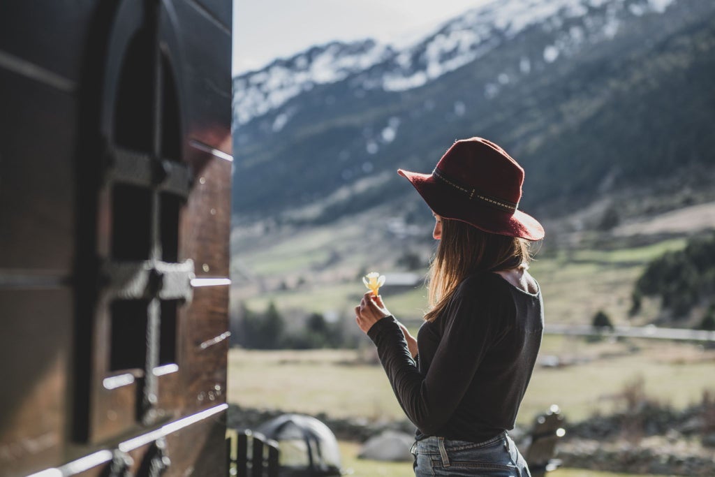 Luxurious mountain lodge nestled in scenic Andorran landscape, featuring rustic wooden architecture, snow-capped peaks, and elegant alpine design elements