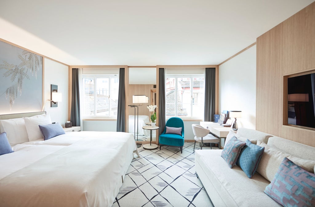 Modern hotel room with elegant floor-to-ceiling windows, plush queen bed, designer furniture, and stunning Zurich city views in natural light