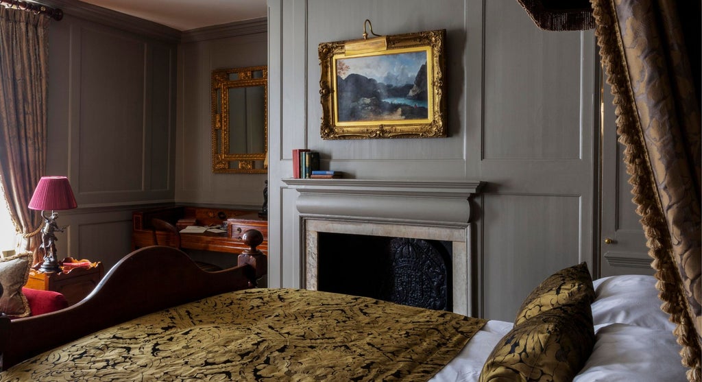 Elegant superior double room at Hazlitt's, featuring plush bedding, ornate period furnishings, and soft lighting in a luxurious United Kingdom boutique hotel setting.