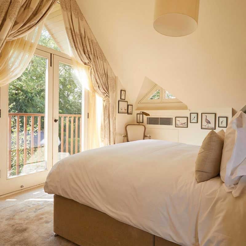 Luxurious studio room with contemporary design, featuring plush bed, elegant seating area, and warm neutral tones at Scenset Dormy House Hotel & Spa in the United Kingdom.