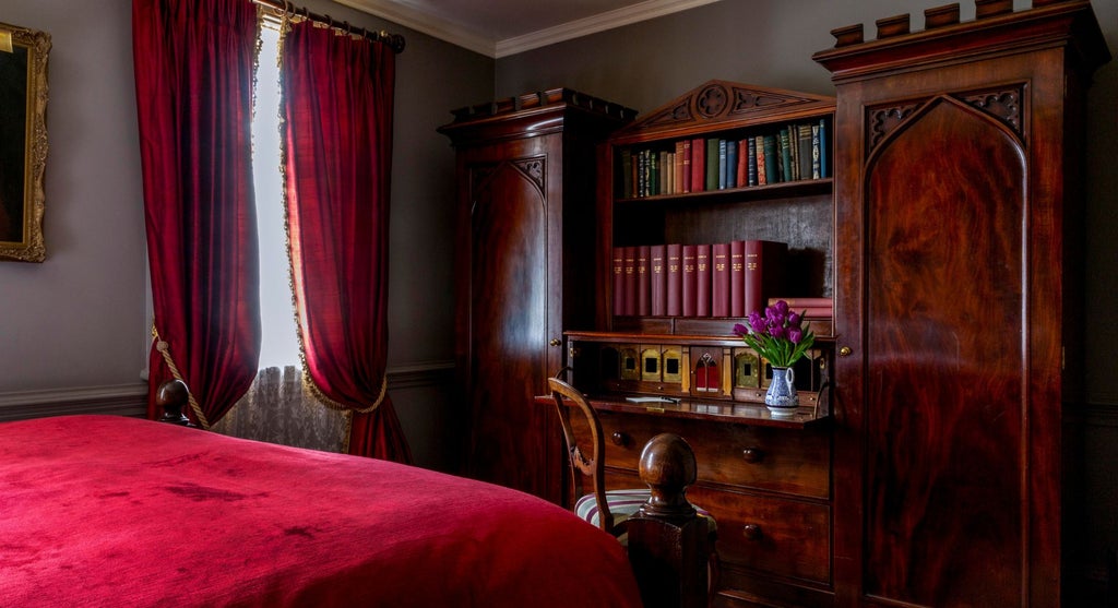 Opulent club double hotel room with plush velvet headboard, antique furnishings, and rich jewel-toned decor at Batty Langley's boutique luxury accommodation in United Kingdom