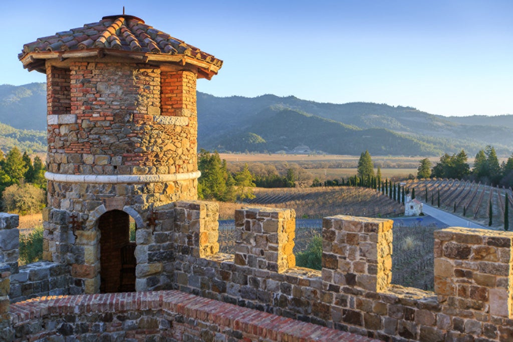 Contemporary resort set amidst rolling vineyard hills with infinity pool, stone facade and luxurious outdoor terrace in Napa Valley