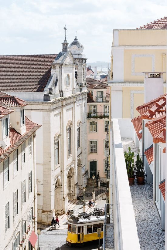 Luxurious white-walled boutique apartment in Lisbon with minimalist design, featuring elegant furnishings and warm wooden accents, showcasing Portuguese architectural charm