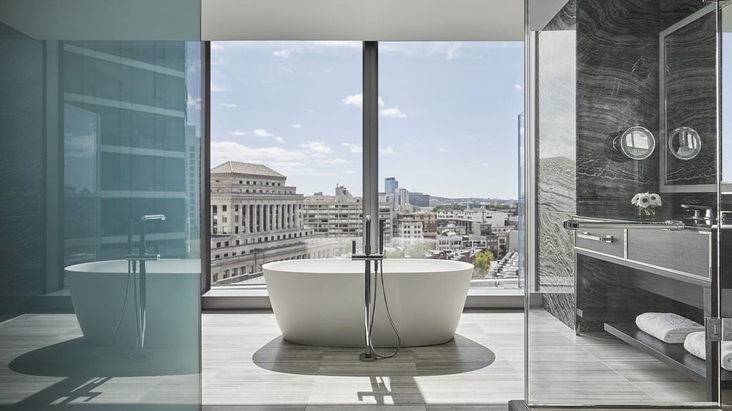 Luxurious Four Seasons Charles Suite in Boston, featuring elegant contemporary decor, plush king bed, city view, and sophisticated neutral color palette