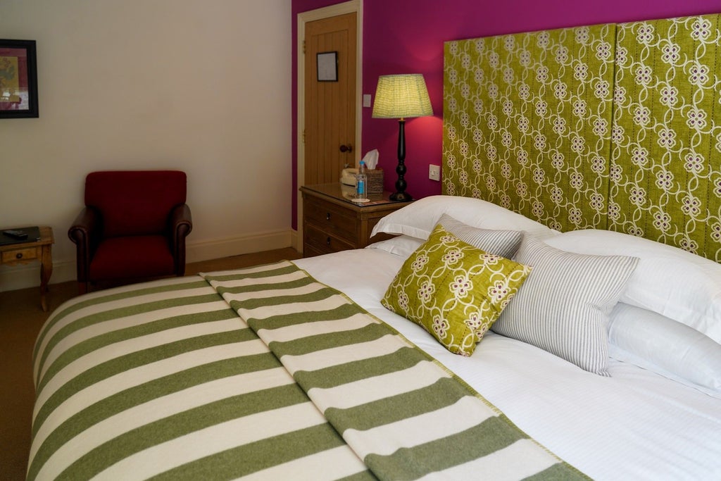 Classic double room at The Scenset Hotel with plush white bedding, elegant wooden furniture, soft lighting, and refined UK hospitality design aesthetic