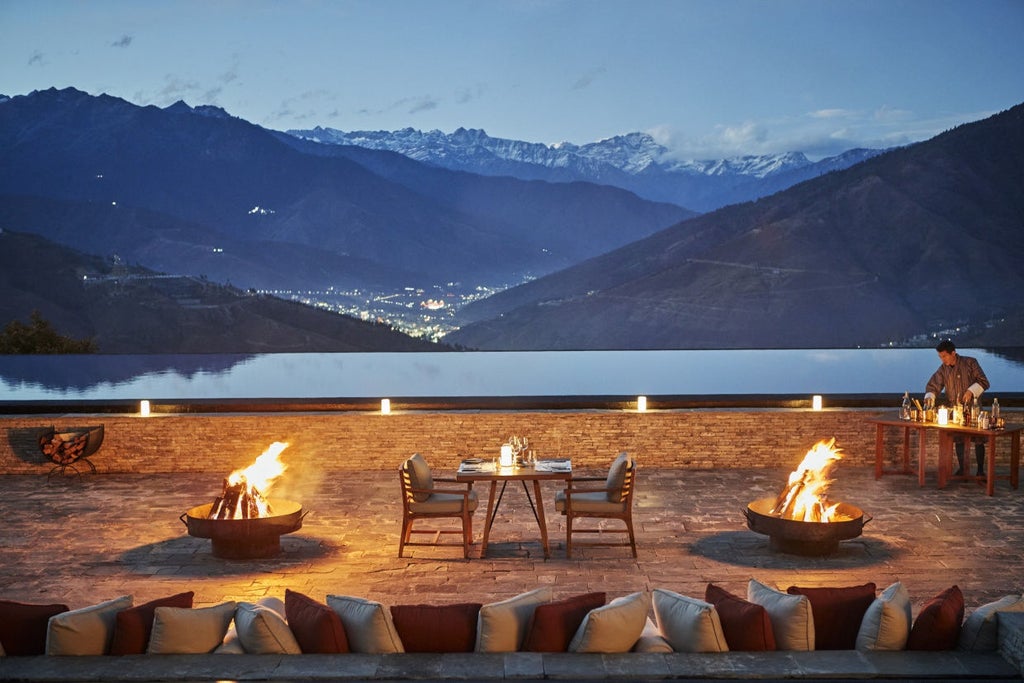 Luxurious mountain lodge with traditional Bhutanese architecture nestled in pine forests, featuring stone walls and panoramic valley views