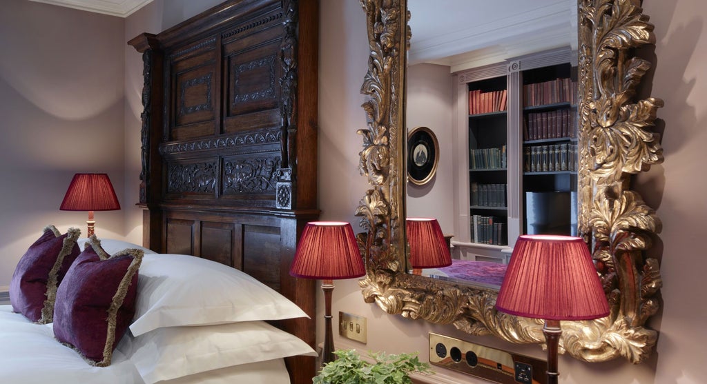 Opulent club double room at Batty Langley's, featuring rich dark wood, plush velvet furnishings, and vintage-inspired elegant British design elements