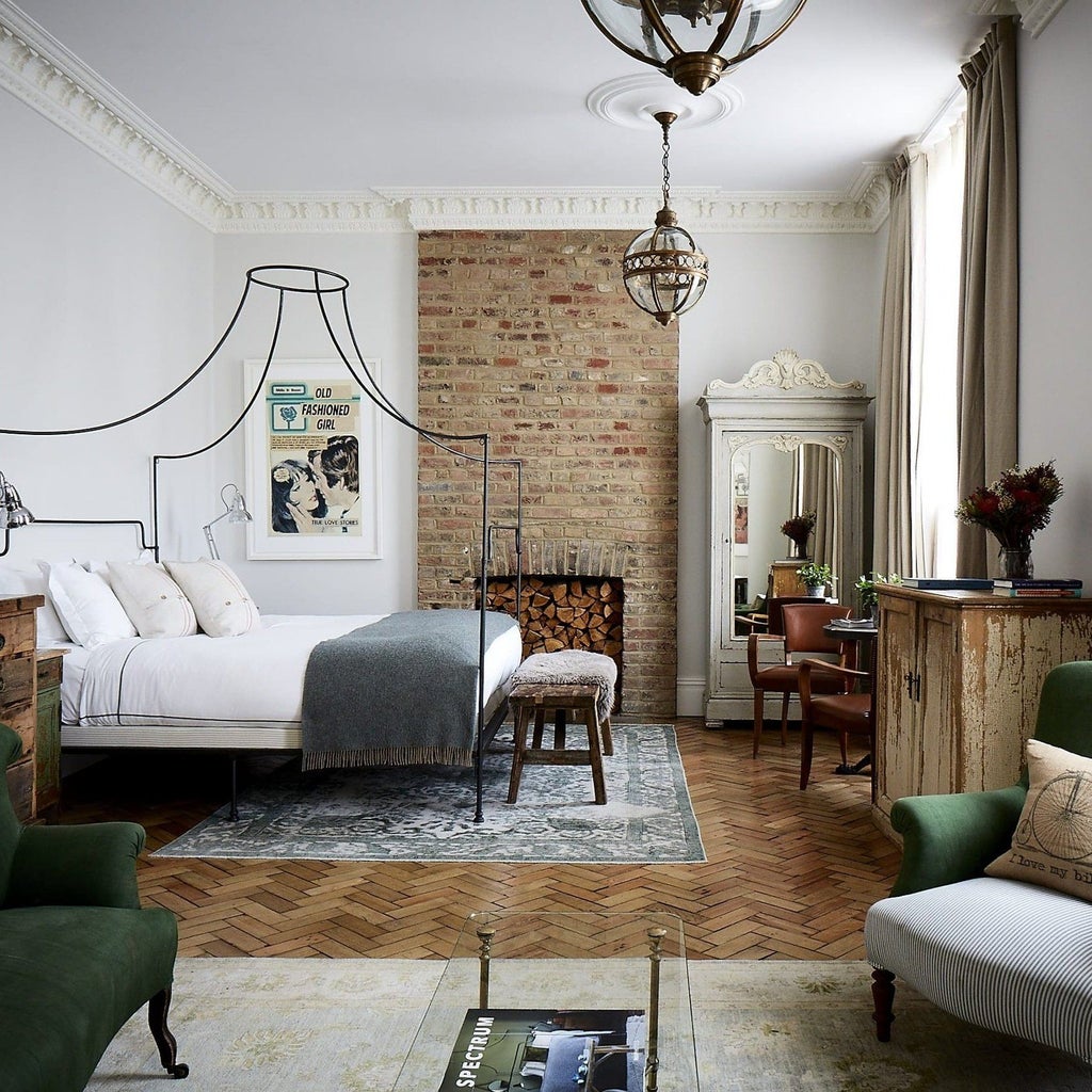 Luxurious boutique hotel room in scenset, featuring eclectic artwork, plush bedding, and vintage-inspired design elements in a chic, intimate space.