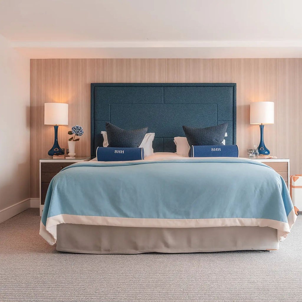 Spacious Marina View Suite with private balcony overlooking Southampton's waterfront, featuring modern decor, elegant furnishings, and panoramic harbor scenery.